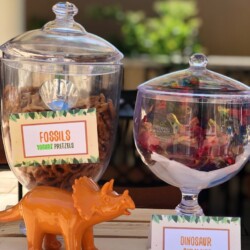 A table with two jars filled with food and toys.