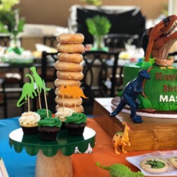 A table with cupcakes and cakes on it