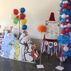 A cat in the hat themed party with balloons and decorations.