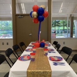 A table with balloons and plates on it
