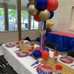 A table set up with balloons and plates
