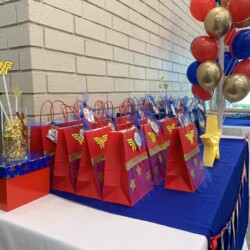 A table with several bags of candy on it.