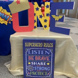 A table with a sign and a superhero sign