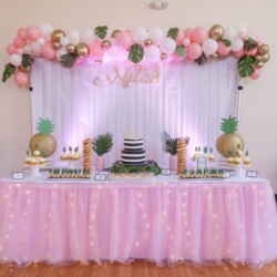 A table with pink and white balloons on it