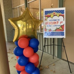 A balloon star is on the top of this tall stand.