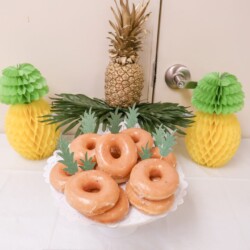 A white plate topped with donuts covered in frosting.