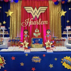 A table with a cake and other decorations on it.