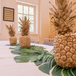A table with three pineapples on it