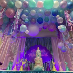 A room with balloons and lights in it