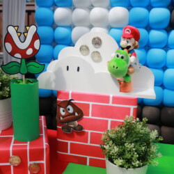 A mario themed party with balloons and decorations.