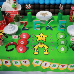 A table with decorations and a cake for a birthday party.