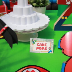 A table with cake pops and mario characters.