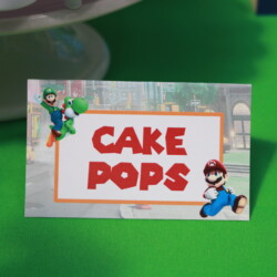 A cake pops sign with mario and luigi on it.