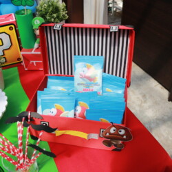 A red suitcase with many packages of candy