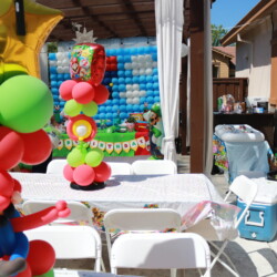 A table with chairs and balloons on it