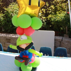 A balloon sculpture of mario and the star.