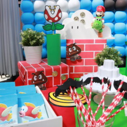 A table with decorations and party supplies for mario bros.