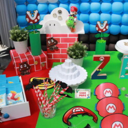 A table with decorations and party supplies for mario bros.