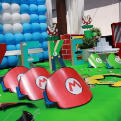 A table with mario hats and balloons on it