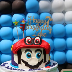 A cake with a mario face on it