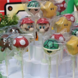 A bunch of cake pops that are on a table