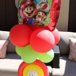 A balloon decoration with mario and luigi on it.
