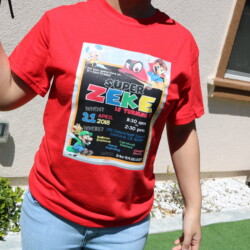 A person wearing a red shirt holding a frisbee.
