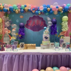 A table with balloons and decorations on it