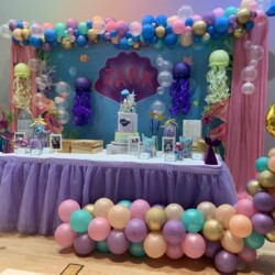 A table with balloons and decorations on it