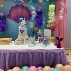 A table with balloons and decorations on it