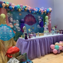 A table with balloons and decorations on it