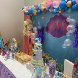 A table with balloons and other decorations on it