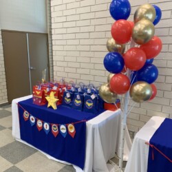 A table with balloons and decorations on it