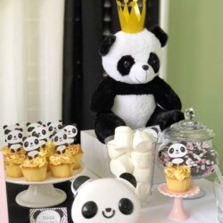 A table with panda bear cupcakes and cookies