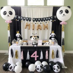 A table with balloons and decorations on it