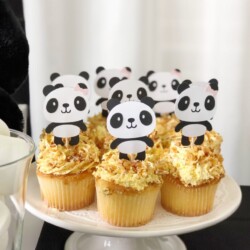 A white plate topped with cupcakes covered in frosting.