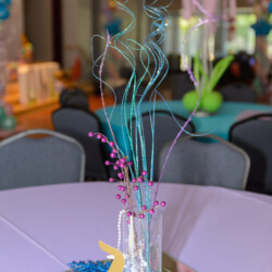 A table with a vase of flowers on it