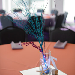 A table with a vase of flowers on top