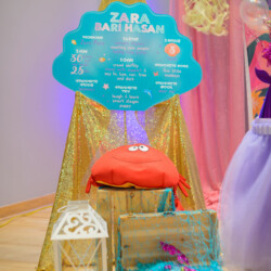 A chair and some bags on display in front of a poster.