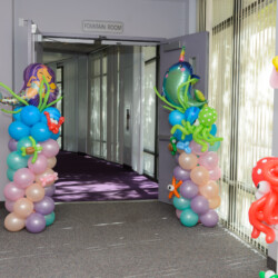 A room with balloons and decorations on the floor.