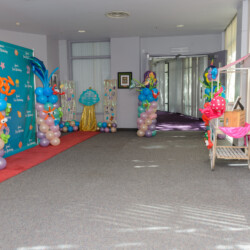 A room with balloons and decorations on the floor.