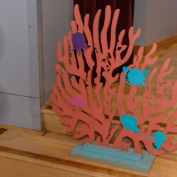 A coral with fish on it is sitting in front of the door.