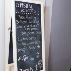 A chalkboard sign with various activities written on it.
