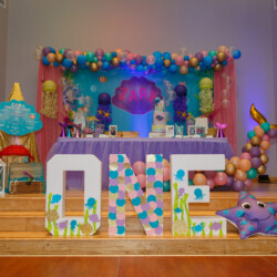 A table with balloons and decorations on it
