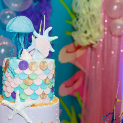 A cake with a sea creature on top of it.