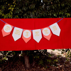 A red banner with gold lettering hanging from it.