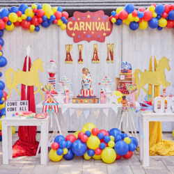 A carnival themed birthday party with balloons and decorations.
