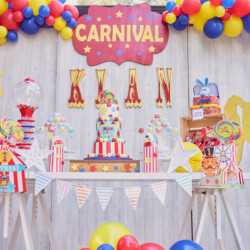 A carnival themed birthday party with balloons and decorations.
