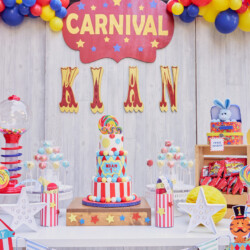 A table with a cake and balloons on it