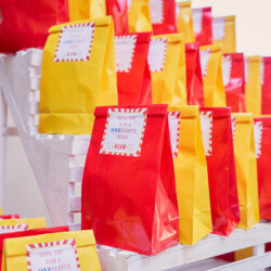 A display of red and yellow bags on a shelf.